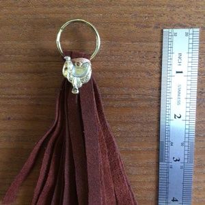 Brown faux soft leather tassel with gold tone western saddle bling